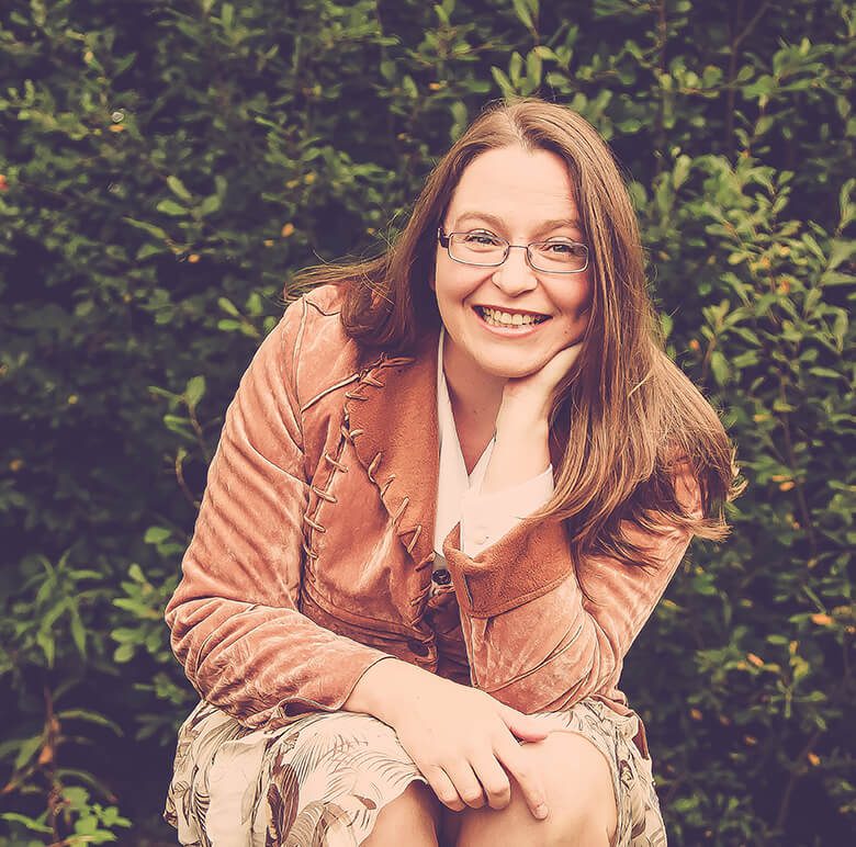 Author Dawn Chapman seated leaning forward