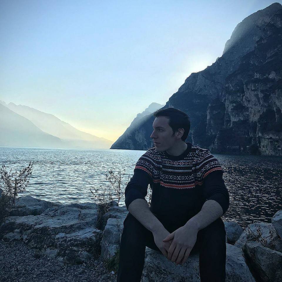 James Wolanyk author photo by a rocky lake shore